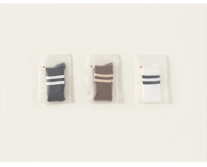 Three pairs of striped cotton mid-calf socks in black brown and white in frosted bags