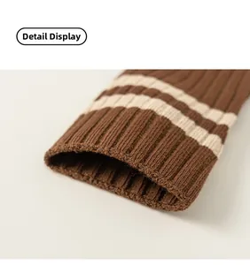 Detailed macro view of brown ribbed knit cuffs with two cream-colored stripes