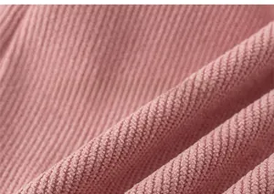 Detailed macro view of pink vertical ribbed knit fabric texture for warm toddler pants