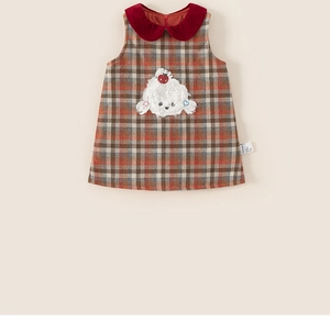 Detail of girls plaid sleeveless dress featuring red Peter Pan collar and dog patch embroidery