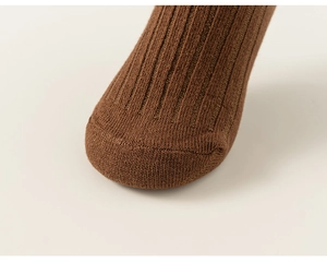 Close-up of brown ribbed cotton socks showing seamless toe stitching and knit texture