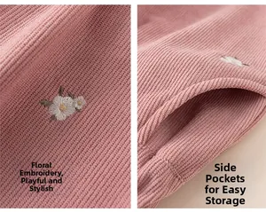 Close-up of pink corduroy toddler pants featuring floral embroidery and side pockets