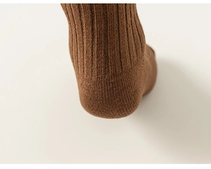 Macro shot of the ribbed texture and heel of coffee brown cotton knee-high socks
