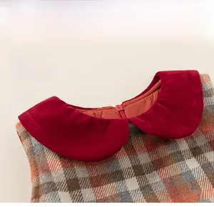 Detail of red velvet Peter Pan collar and hidden back zipper on girls plaid dress