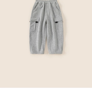 Detail view of grey children's knit cargo joggers with side flap pockets and ribbon accents