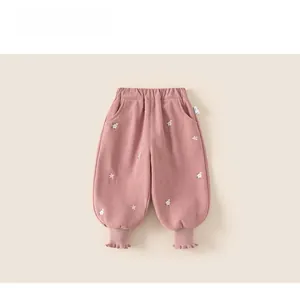 Close-up of pink toddler jogger with floral embroidery and ruffle elastic cuffs