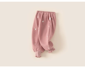 Detail of pink fleece pants for girls featuring floral embroidery and ruffle cuffs