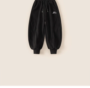 Detail of kids black jogger pants with white smile embroidery and drawstring waist