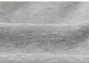 Close-up of soft grey knit fabric texture for children's winter sport trousers