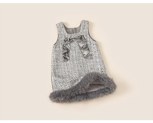 Detailed view of kids sequin dress featuring pearl neckline and velvet bow accent