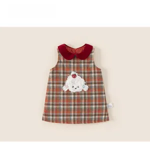 Detail of girls plaid sleeveless dress with red Peter Pan collar and puppy embroidery