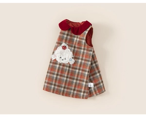 Close-up of winter girls plaid dress featuring a red collar and cute lamb applique detail