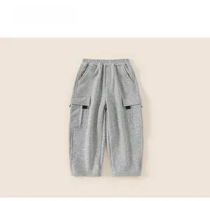 Detailed view of grey kids' sports pants with elastic waist and large cargo pockets