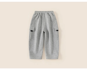 Detail view of grey kids joggers featuring elastic waist and utility cargo pockets