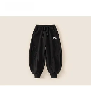 Detail view of black kids winter joggers with smile face embroidery and drawstring waist