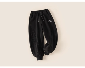 Detail of kids black winter sweatpants with drawstring waist and smile embroidery