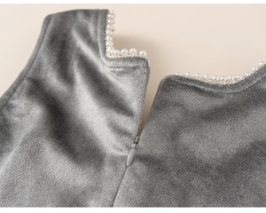 Detail of grey velvet dress showing pearl beaded collar and back invisible zipper