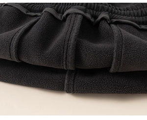 Close-up of boys' winter pants showing soft fleece lining and elastic waistband details