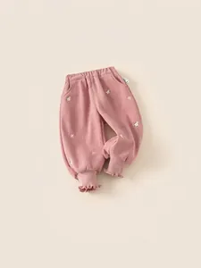 Girl's pink corduroy joggers with white flower embroidery and ruffled elastic cuffs
