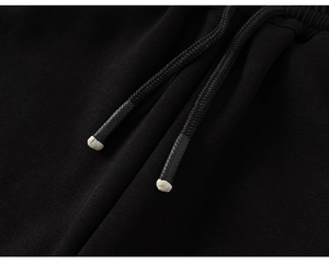 Macro shot of black knitted drawstring with premium white plastic dipped tips detail