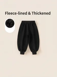 Winter fleece-lined joggers for boys in black, featuring elastic waist and warm ribbed cuffs