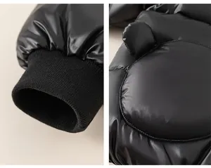 Detail of waterproof glossy black kid's jacket with windproof ribbed cuffs and cute ears