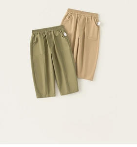 Detail of olive green and khaki cotton pants featuring elastic waist and side pockets