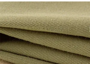 Macro shot of khaki cotton twill fabric showing soft texture and premium thick weave