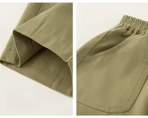 Detail view of military green boys cargo pants showing elastic drawstring and side pockets