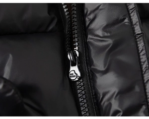 Detail of high-quality metal zipper with INS BOBO engraving on black puffer jacket