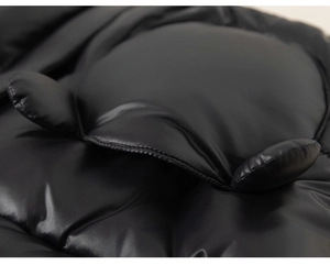 Close-up of waterproof fabric and cute round ear design on child hooded jacket
