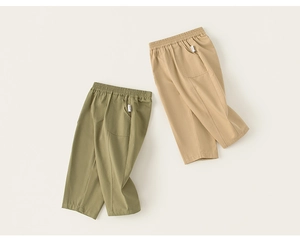Detail of elastic waistband and decorative stitching on kids straight casual trousers