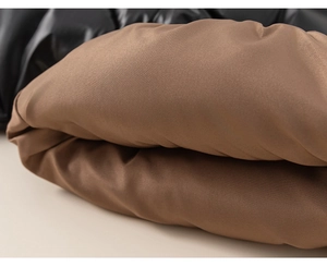 Macro detail of waterproof brown and black padded fabric on child's winter coat