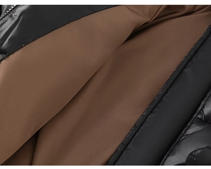Detail of waterproof kids jacket showing shiny black exterior and brown matte lining