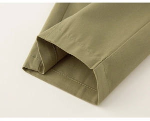 Detailed macro view of olive green twill cotton fabric with high-quality uniform stitching