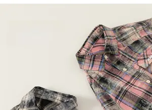 Close-up of vintage plaid flannel shirt showing cotton texture and button detail