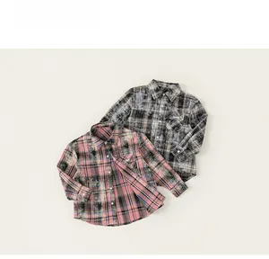 Detail of vintage plaid cotton shirts for boys with washed texture and front pockets