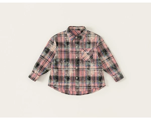 Detail of checkered boys shirt with distressed wash effect and need embroidered pocket