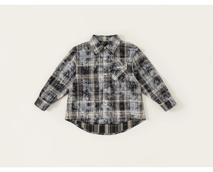 Detail view of boys' plaid shirt featuring vintage bleached tie-dye fabric and chest pocket