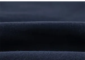 Macro shot of navy blue knit fabric texture showing fine weave and soft cotton material