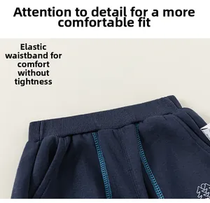 Detail of navy blue kids joggers featuring elastic waistband and contrast blue stitching