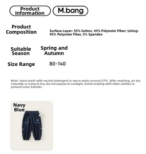 Detail view of navy blue kids joggers with material composition and size chart information