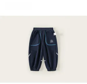 Detail of navy blue kids joggers featuring elastic waist and pine tree logo printing