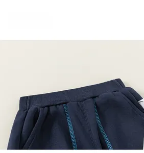 Detail of navy blue kids joggers with elastic waistband and decorative stitching