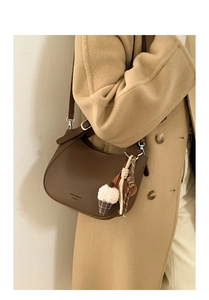 Brown lychee leather crossbody bag with ice cream charm and plaid ribbon detail