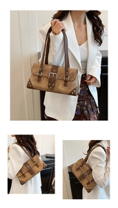 Detail view of vintage brown rivet shoulder bag showing suede texture and stud accents
