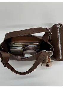 Top view of dark brown pebbled leather bucket bag showing spacious interior with essentials