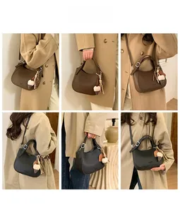 Close-up of crescent bucket bag showing litchi grain leather and ice cream charms