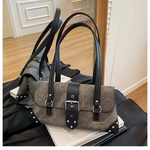 Detailed close-up of retro motorcycle bag with silver rivets and buckled leather straps