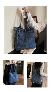 Detailed view of blue denim tote bag featuring vintage waistband and metal button accents